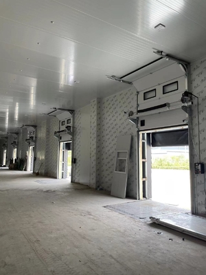 sectional door is opened vertically or bendly suspending under the ceiling by electric operation