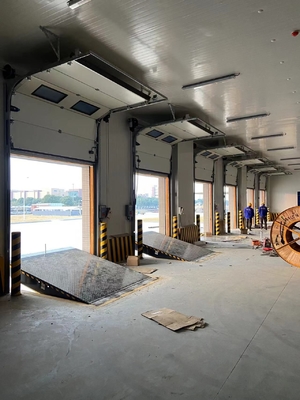 sectional door is opened vertically or bendly suspending under the ceiling by electric operation